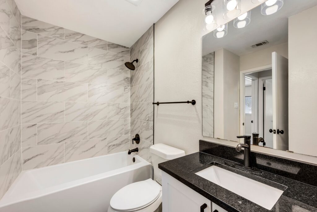 Eggshell and black bathroom remodel for family home.